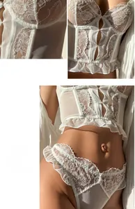 Detailed white lace embroidery with ruffled hem on sheer mesh corset bra and panty set