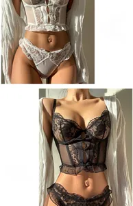 Detailed view of French lace corsets in white and black with intricate floral embroidery