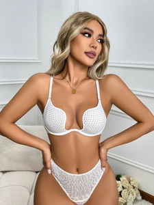 Detail of white U-shaped push-up bra with mesh texture and matching leopard print panties