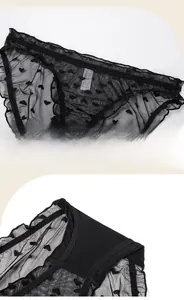 Detail of black lace panties with heart jacquard pattern and soft ruffle trim textures