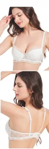 Detail showing white lace bra with heart patterns and ruffled straps on model back