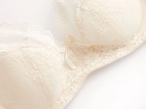 Close-up of elegant floral lace texture and bow detail on French-style underwire bra