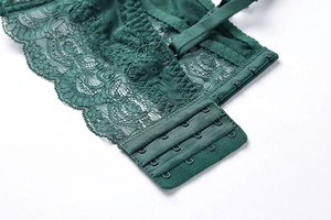 Close-up of the deep green lace bra back featuring four-row hook-and-eye closure detail