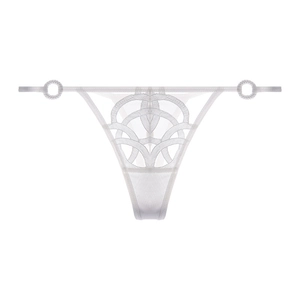 Close-up of white lace thong featuring geometric embroidery and metallic ring details