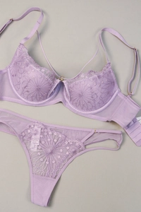 Detail of light purple floral lace embroidery on sheer mesh bra and matching thong set