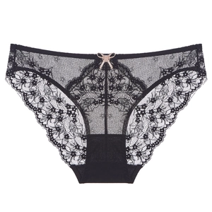 Black floral lace panties with mesh panels and a small silk bow on a white background