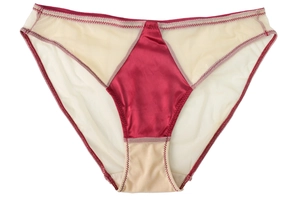 Detailed close-up of seamless burgundy satin and beige mesh stitching on panties
