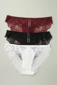 Detailed view of three lace panties in red, black and white with cotton crotch lining