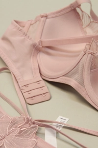 Detailed embroidery on French lace lingerie set featuring delicate floral patterns