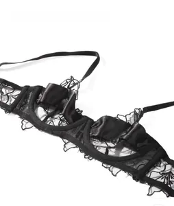 Close-up of black floral lace and satin bra detailing with delicate shoulder strap texture