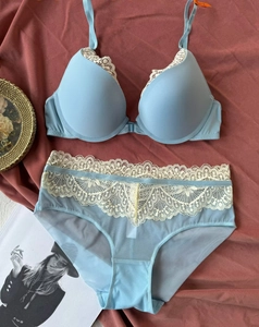 Detailed view of light blue lace lingerie set with front closure and mesh panty