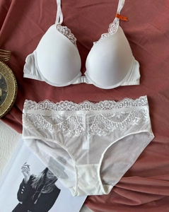 Detailed view of white lace lingerie set with front-closure bra and sheer mesh panties