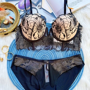 Detail of black floral embroidery on a 3/4 cup lace bra and matching panty set