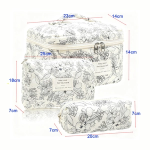 Quilted floral cotton toiletry bag set with three cosmetic storage cases in white and black