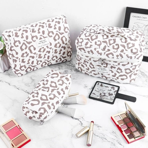 Three-piece leopard print quilted makeup bag set including a large vanity case and pouches