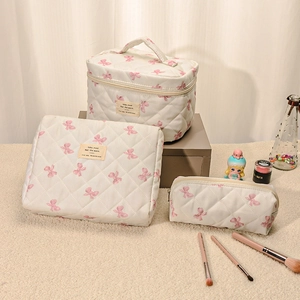Three-piece quilted cotton cosmetic bag set with cute pink bow pattern and top handle