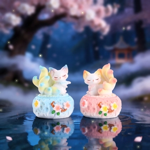 Detailed view of mythical nine-tailed fox resin figurines with cherry blossom base