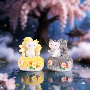 Nine-tailed fox incense burner figurines with floral base on a water surface