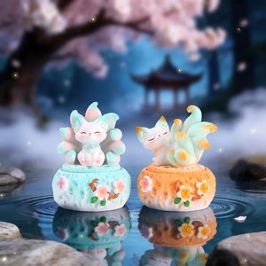 Macro detail of Nine-tailed Fox incense burner statues with floral bases over water