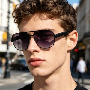 Close-up of men's matte black metal pilot sunglasses with purple gradient lenses