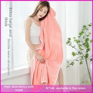 Close-up of thick coral pink microfiber bath towel featuring ultra soft absorbent texture