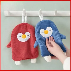 Detail of hanging penguin hand towels made of thick coral fleece in red and blue