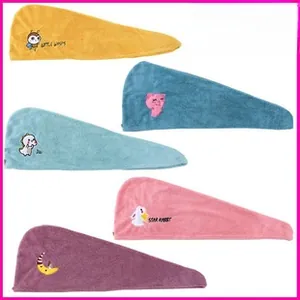 Detailed stack of absorbent coral fleece hair towels in five vibrant cartoon colors