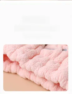 Close-up of soft pink coral fleece fabric texture for absorbent kids hair drying towel