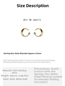 Macro detail of 8.5mm moon stud earrings in S925 sterling silver with 14K gold plating