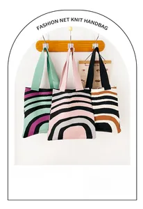 Detailed view of knitted tote bags with striped wave patterns hanging on wooden wall hooks