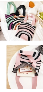 Detailed view of colorful striped knitted tote bags showing soft texture and large capacity