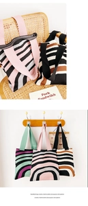 Detail of knitted tote bags with wavy stripes in pink, green and brown color options