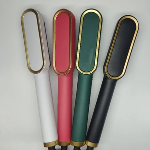 Negative ion hair straightener brush in white, pink, green, and black with gold ring
