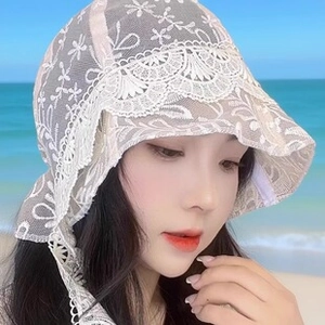 Detail of white crochet floral lace sun hat with scalloped edges and adjustable ties