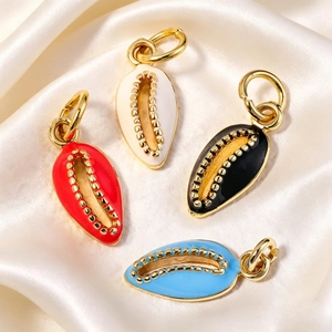 Set of four colorful enamel conch shell pendants with gold beaded edges on silk fabric