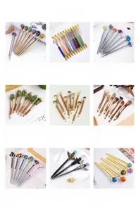 Detail showcasing variety of natural crystal metal pens with gemstones and floral elements
