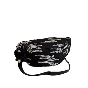 Black quilted chest bag with colorful wave embroidery and a plush soot sprite charm