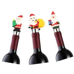 Three Christmas Santa wine stoppers with metal base and rubber seal on white background