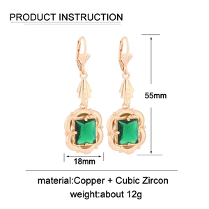 Macro view showing dimensions and materials of copper earrings with emerald crystals