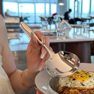 Polished stainless steel serving spoon with ergonomic handle for dining and catering