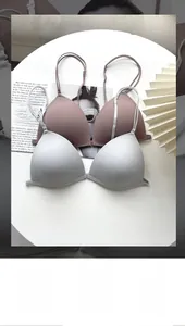 Detailed view of seamless front-closure triangle bras in soft pink and light grey colors
