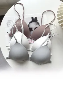 Flat lay of seamless wire-free bras with front buckles and slim straps in three colors