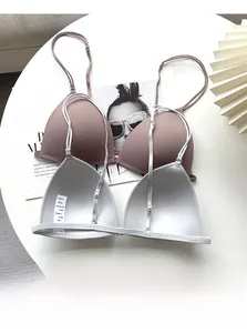 Detailed close-up of seamless wireless bras in pink and grey showing delicate thin straps