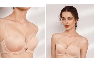 Detail of a seamless beige bra featuring cross-cut center with subtle rhinestone accents