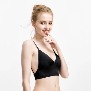 Detail view of black deep V backless bra with thin adjustable straps and seamless fabric