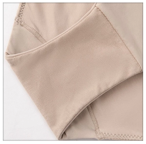 Macro shot of nude push-up bra featuring seamless elastic band and fine stitching detail