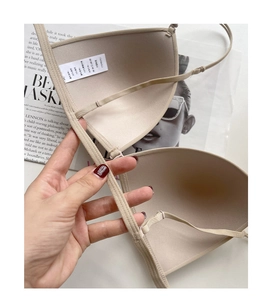 Detailed close-up of seamless beige bra inner lining with soft fabric and washing label