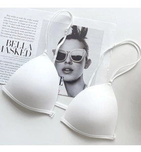 Detail of white triangle bra with adjustable thin straps and smooth seamless fabric finish