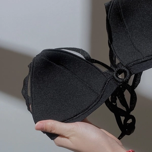 Detail of breathable mesh interior and delicate texture of a black wireless bra cup