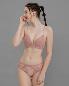 Detailed close-up of pink lace lingerie set featuring triangle cups and matching panties